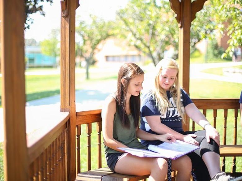 students sitting on gazebo at Penn State DuBois